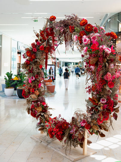 Large Christmas wreath installation created by Sweet Stems for Bayfair shopping centre in Tauranga. Corporate floral styling with seasonal foliage and natural textures.