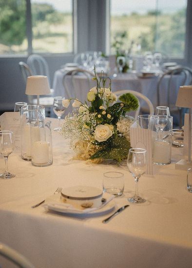 Elegant white and green floral centrepiece on a corporate awards dinner table.