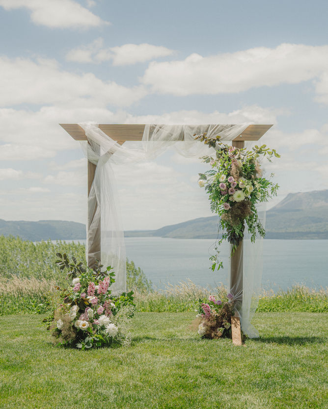 Soft lilac, blush and white wedding arch for Kimberly and Brad at Black Barn by Sweet Stems featuring romantic garden-inspired florals and soft modern styling
