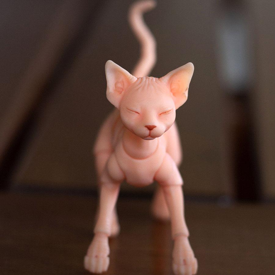 Thumbnail: Poseable orange Sphynx resin cat with emerald eyes showing a curious facial expression.