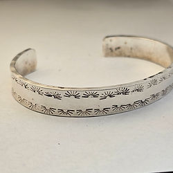 Silver cuff bracelet with engraved floral pattern