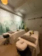 White sliding barn door entrance in a forest-themed spa treatment room.