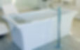 Picture of a deep, freestanding white bathtub in a modern bathroom