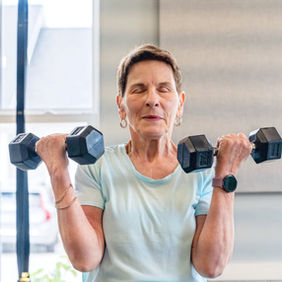 A woman performing a bicep curl with free weights
