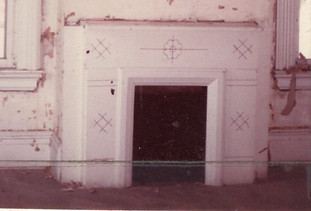 Picture of the parlor fireplace stripped for restoration