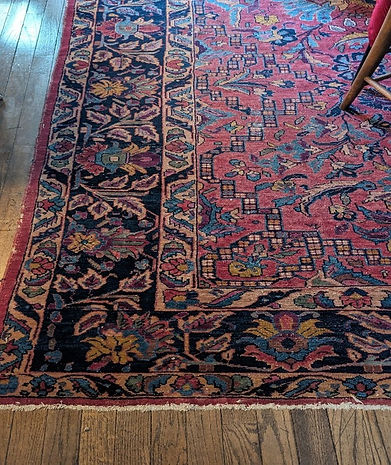 Beuatiful wool rug in black green gold and red.