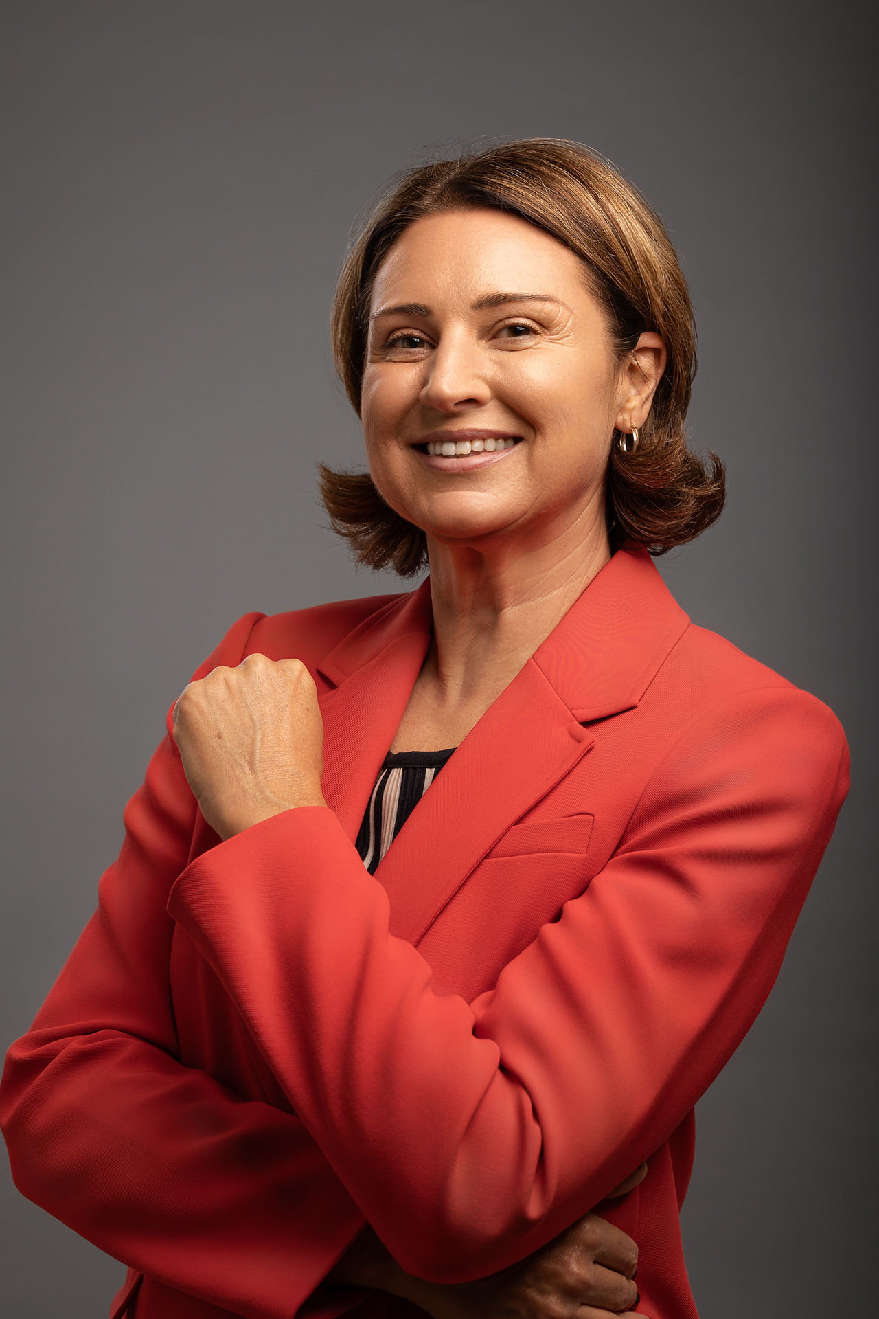 professiona headshot of a women wearing a red blazer