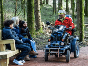     A wheelchair user enjoys the newly accessible Glade Trail at Beechenhurst, located in the heart of the Forest of Dean.