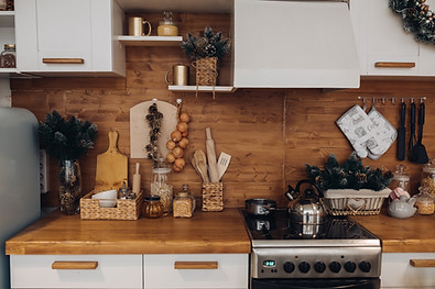 close-up-modern-cozy-kitchen-white-brown-colors-with-stuff-cooker-decorative-fir-tree-bran