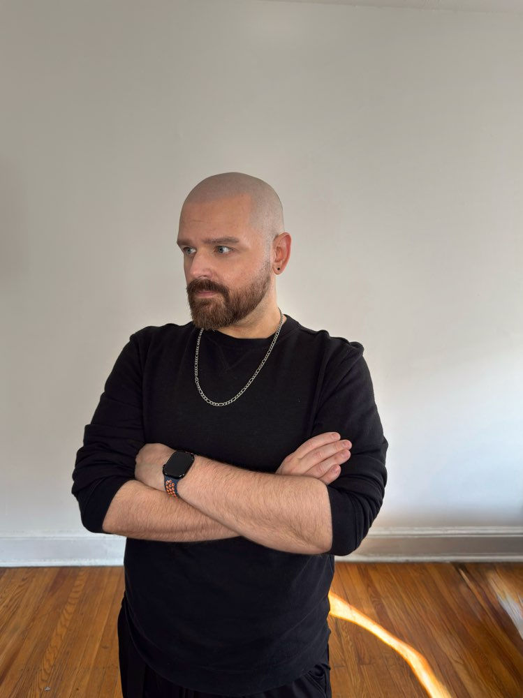 Aiden James: Man in stylish black clothing with silver chain
