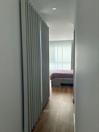 Layered block-out and sheer curtains in Bedroom