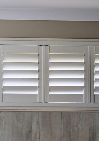 Bi-fold Plantation shutters in bedroom