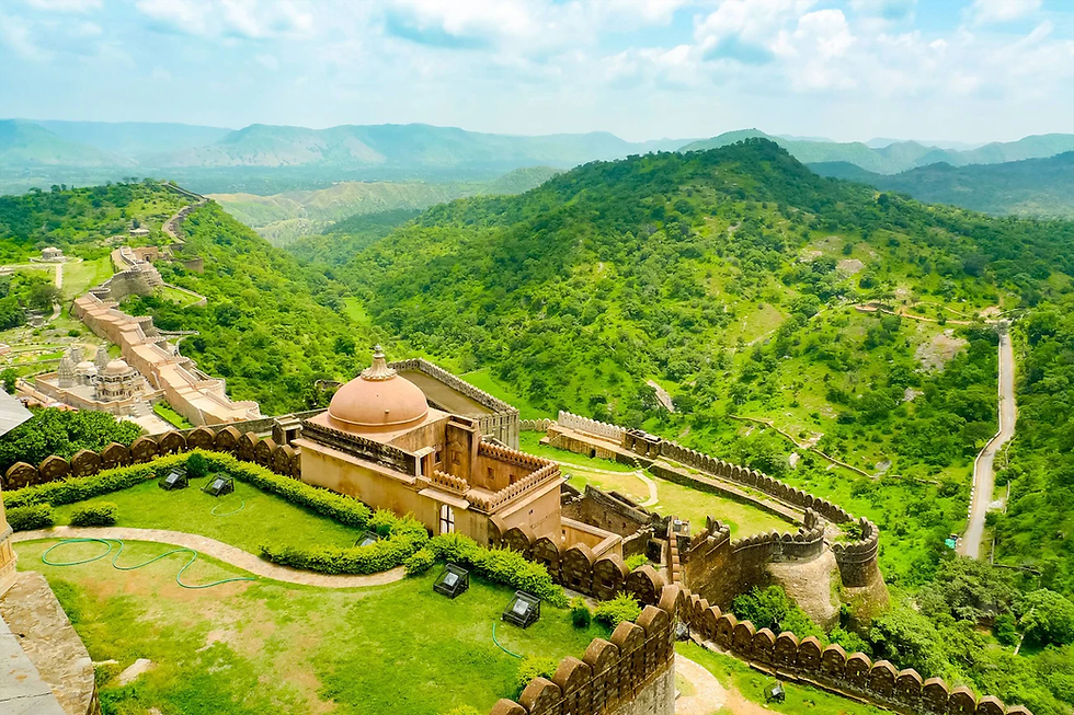 Ancient fort and domed building in lush green mountains