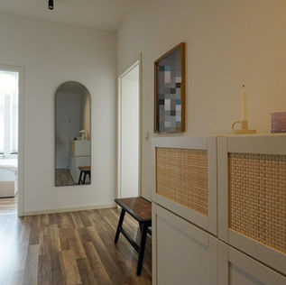 Heller Flur mit Zugang zum Schlafzimmer, Spiegel, Stauraum und gepflegtem Bodenbelag