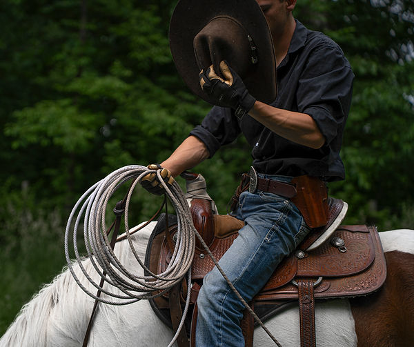 Western portrait of a cowboy with his rope photographed by the lifestyle photographer based in Mchenry County IL Untamed Spirit Imagery
