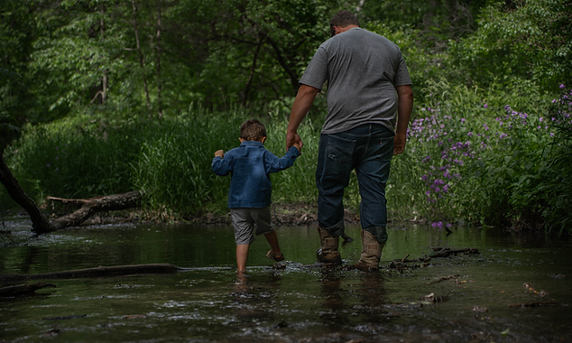 Father and son portrait in a creek photographed by the lifestyle photographer based in Mchenry County IL Untamed Spirit Imagery