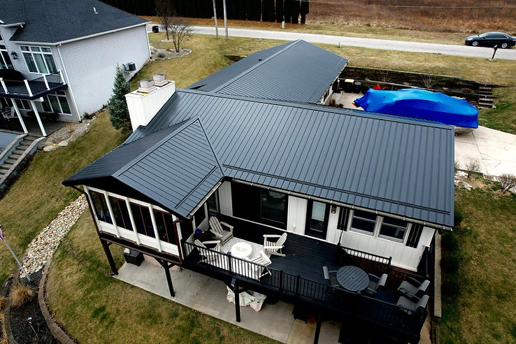 Shield Exteriors metal roofing installation on a lakeside home