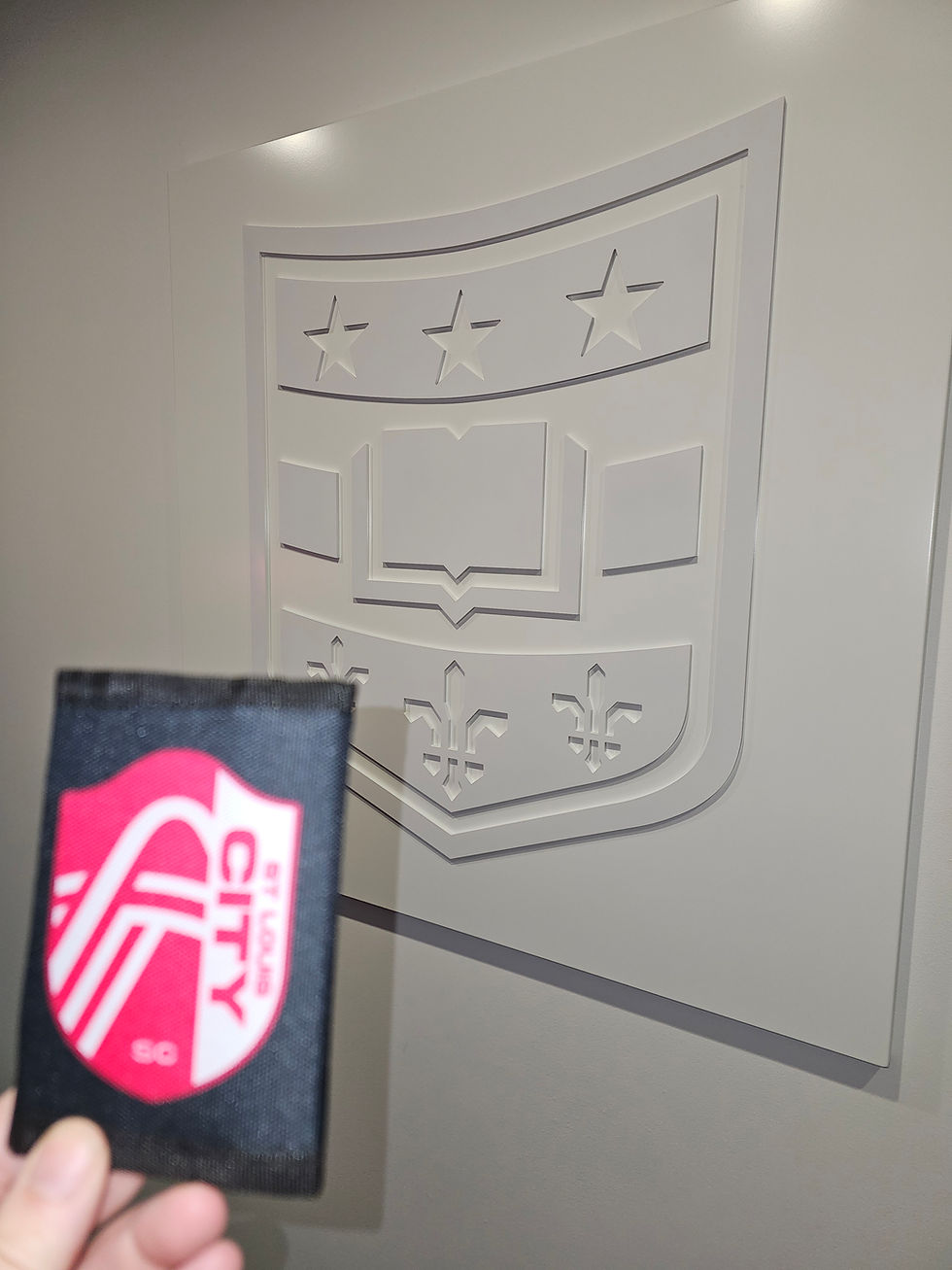 Free Retro 1980s Wallet Promotional Give-Away in Front of the WashU Logo. Photo by Author.