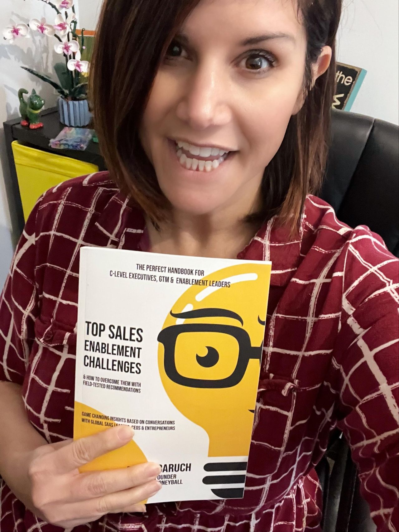 Happy reader holding top sales enablement challenges book