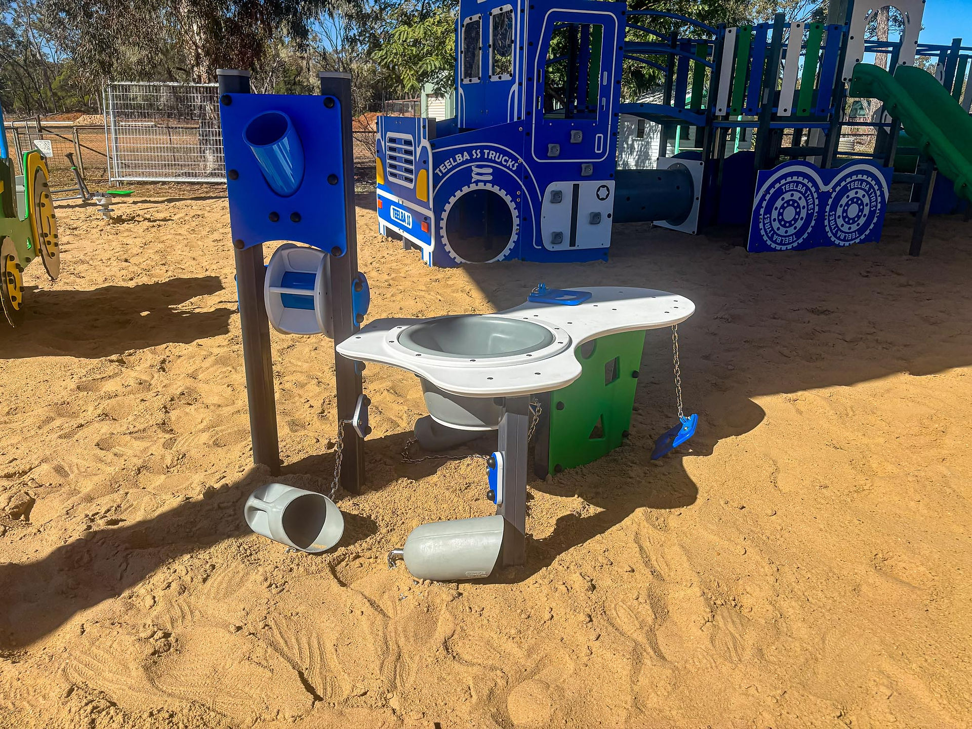 Explore the custom WillPlay playground at Teelba State School, featuring a road-train truck, 'Servo' play fort, sand play area and hard shade shelter.