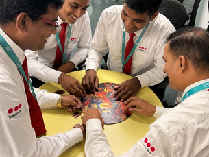 Employees solving a CircZles puzzle together, showing how Diwali Gifts for Employees can create a screen-free workplace experience.