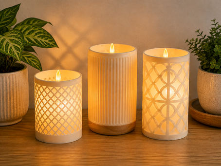 The image shows elegant flameless candles glowing warmly on a wooden surface, creating cozy home décor from The QWERTY Store.