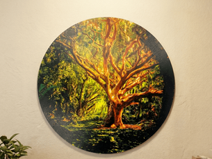A circular Circzles puzzle featuring a vibrant painted tree hangs as wall art, redefining decor as interactive and mindful.