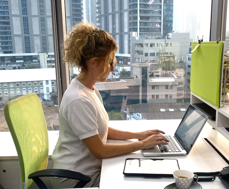 Professional working at a laptop in a modern office, turning ideas into innovative creative solutions