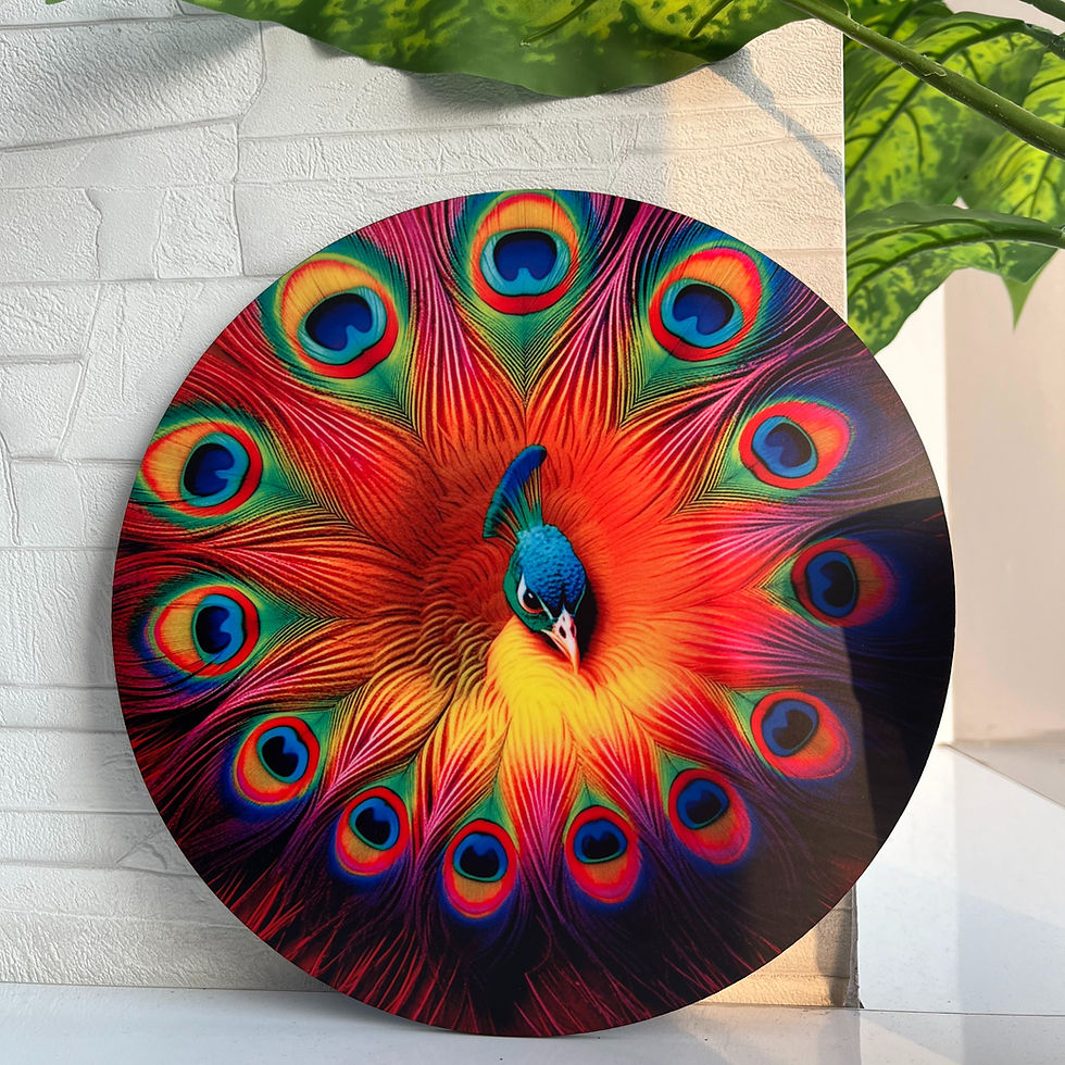 A vibrant circular painting of a peacock with colorful feathers, set against a white textured wall, partially shaded by green leaves.