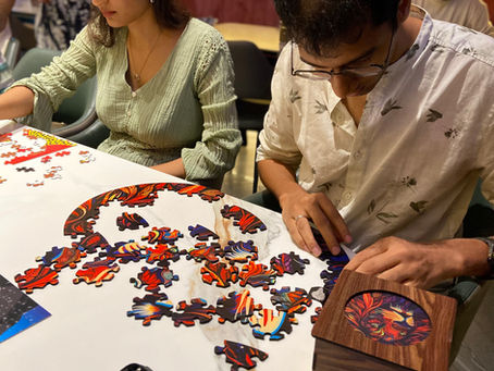 People solving puzzles together at The Puzzle Maniacs, a fun social option for things to do when bored.