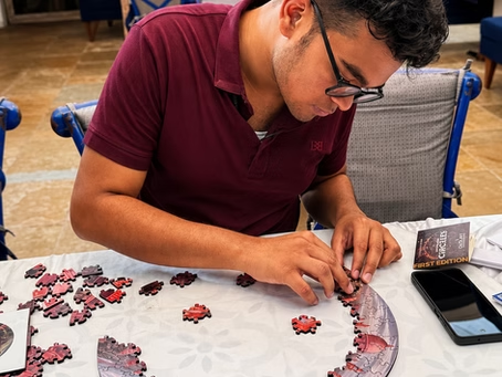 A man solving a circular puzzle, highlighting hands-on brain teasers for adults that test focus, logic and visual thinking.