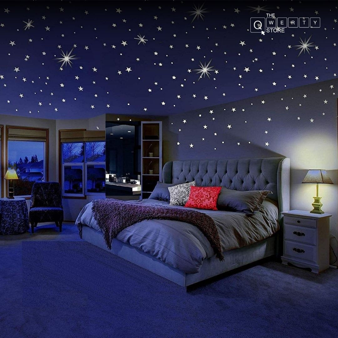 Bedroom with star decorations, bed, windows, and nightstands, dimly lit, cozy setting
