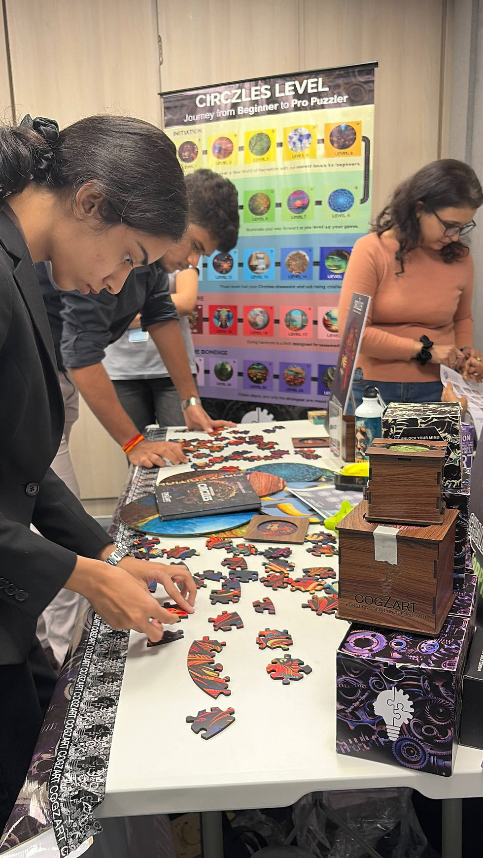 Participants solving hex-based puzzles at CogZart event, encouraging digital detox, attention span improvement, and mental clarity
