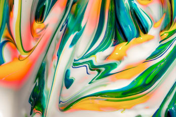 Colorful abstract paint flow with green, orange, yellow, and pink artistic patterns
