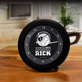 The QWERTY Store black round desk clock with bold graphic print for fun and stylish workspace decor.