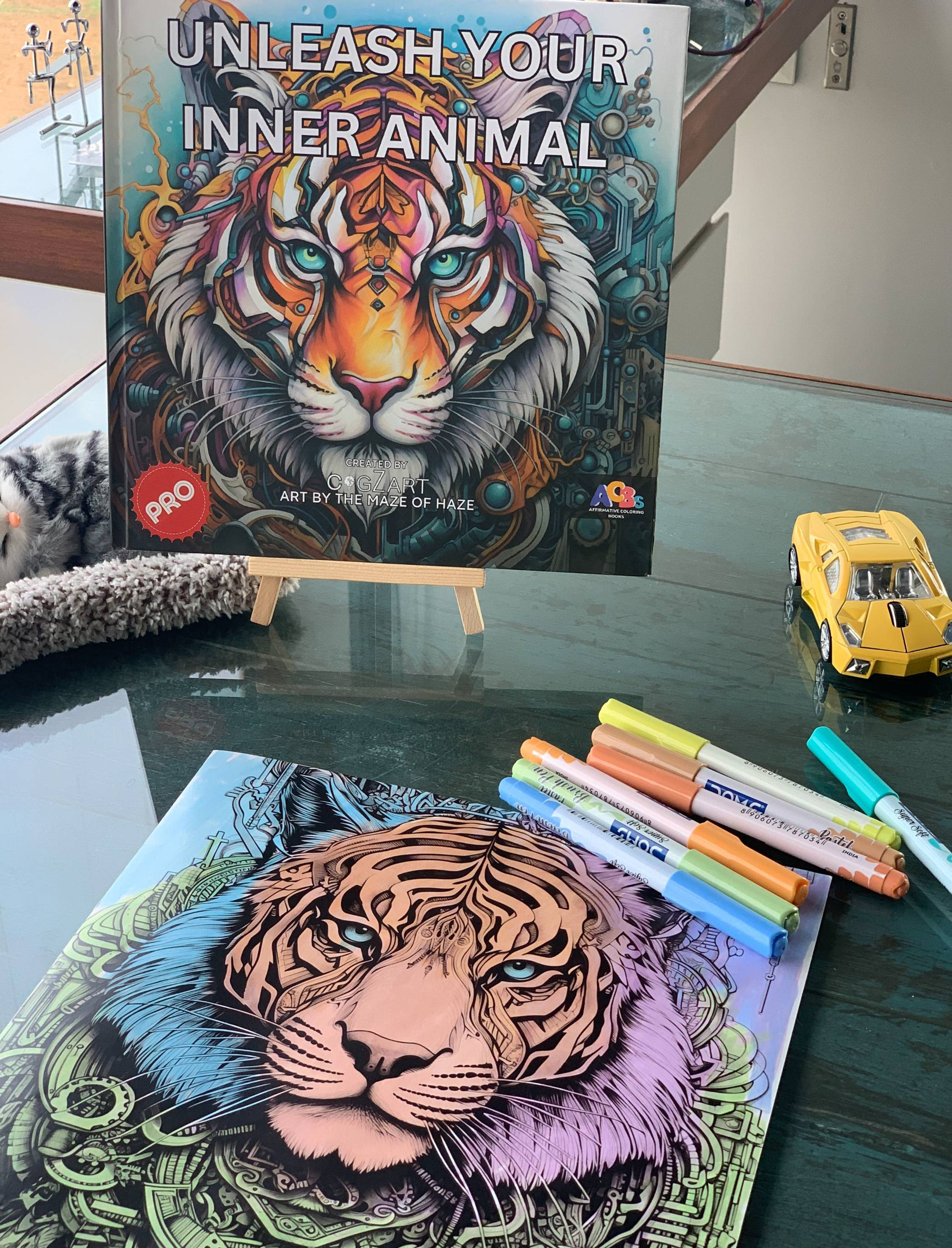 The image shows an ACBs “Unleash Your Inner Animal” coloring book with a tiger artwork and markers, perfect for creative Diwali gifting ideas.