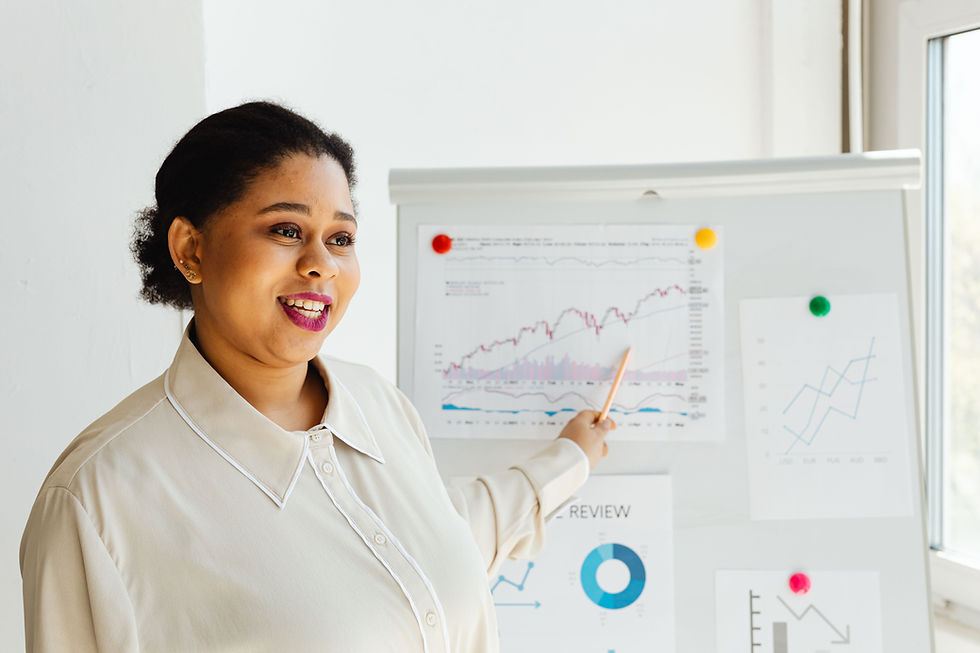 The Qwerty Ink career development session showing a professional presenting performance charts and business insights on a flipboard in a bright office.
