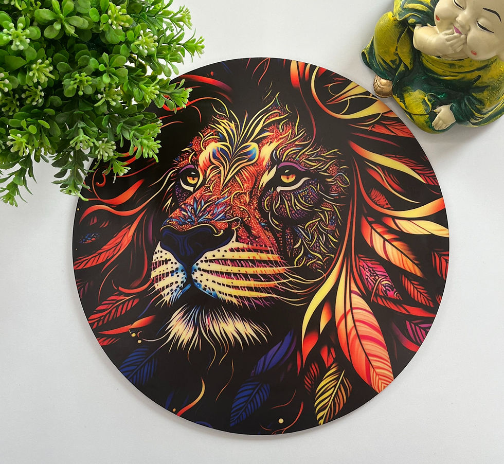 Colorful lion face artwork on a round mat, framed by a green plant on the left and a small figurine on the right, on white background