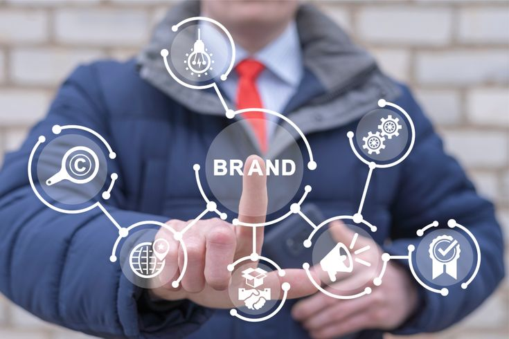 Business handshake with growth, analytics, and strategy icons, representing smart business solutions and professional services by The QWERTY Ink