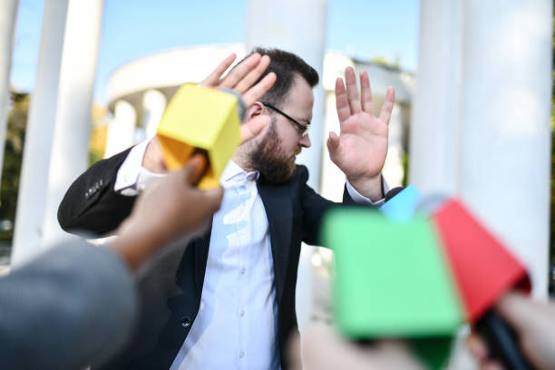 a person holding a mic but refusing to speak.