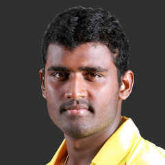 Headshot of a cricketer with a focused expression, wearing cricket gear, captured with professional lighting.