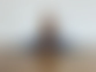 Jakki sitting on her yoga mat