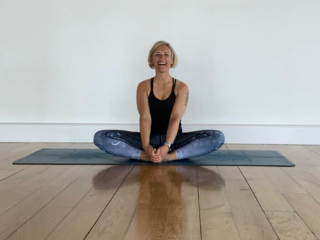Jakki sitting on her yoga mat
