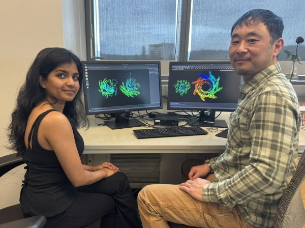 Pooja Bandawane (left) and David E. Kim at computers used in protein design.