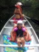 Jason Bailey's children paddling a canoe on a family outing.