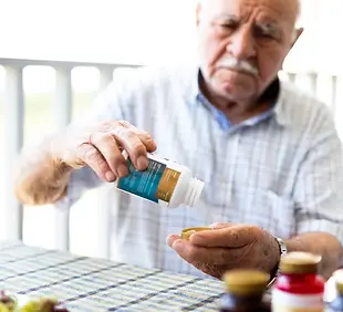elderly-man-taking-vitamins.webp