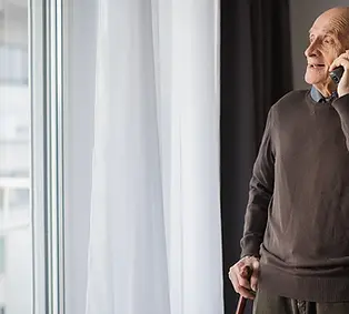 old-man-talks-on-phone.webp
