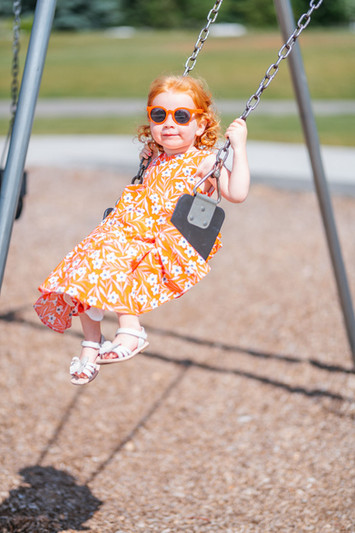 Little Girls Swinging in Custom-Made Dresses - Handmade Fashion for Kids