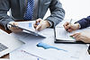 businessmen-elegant-suits-business-meeting-discussing-new-project-office.jpg