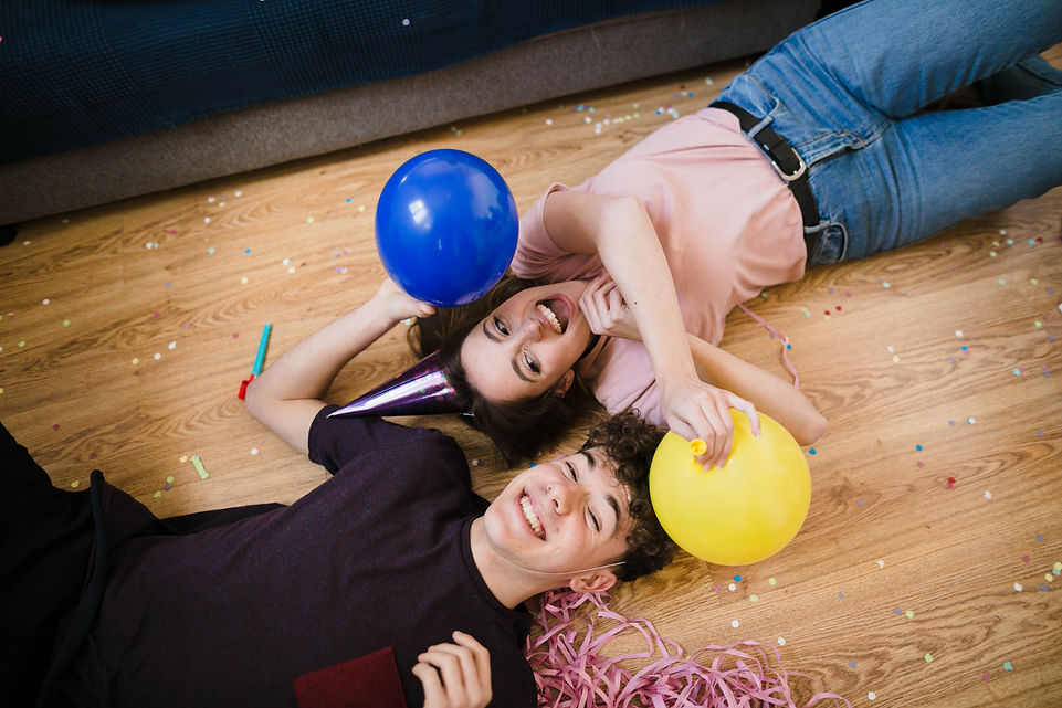 boy-girl-laying-floor-with-balloons.jpg